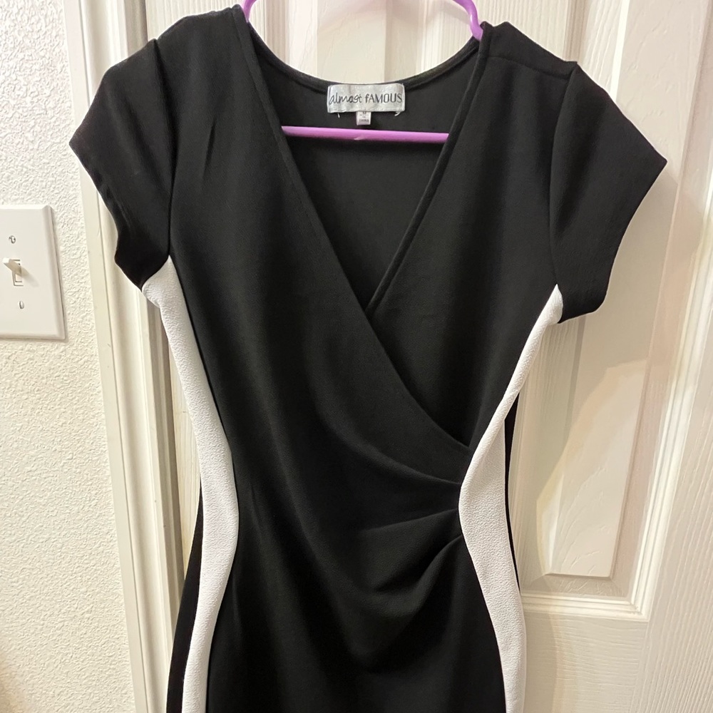 Black fitted mini dress with V-Neck